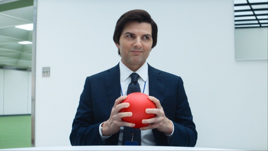 Adam Scott holds a red ball in Severance Season 2.